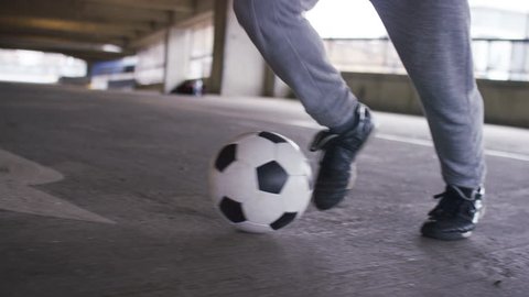 4K Feet of a skillful soccer player doing quick movements with his football