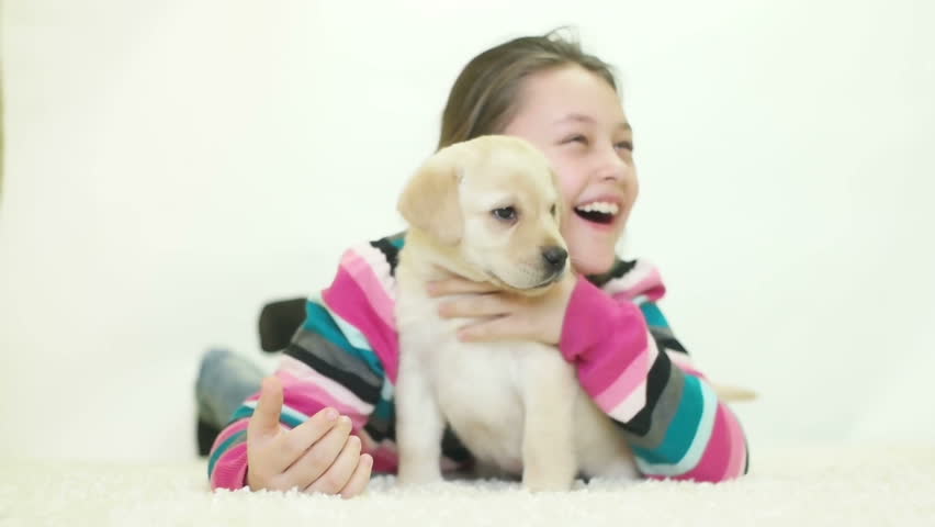 kid playing labrador puppy, slow motion