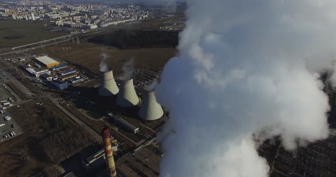 Pollution of the environment: Aerial view of industrial zone with pipes thick white smoke is poured from the factory pipe. Footage 4K