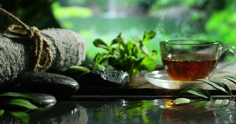 beautiful  green tea in rainy forrest spa in slow motion 