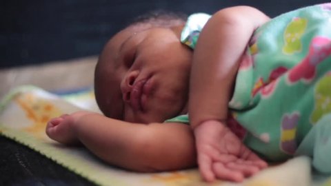 CloseUp of Cute Week Old Baby as she sleeps stretches and dreams