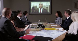 4k Shot of a group of colleagues brainstorming in an office and having a video chat with their boss.
