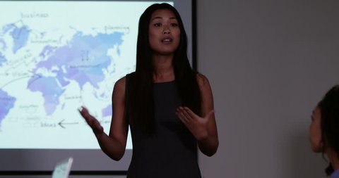 4k, An attractive young Asian female team leader presenting a financial report to his team. Slow motion.