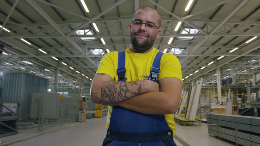 Camera moves around factory worker in warehouse VD Le Marais, Switzerland October, 2015