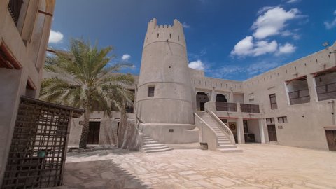 AJMAN, UAE - SEPTEMBER 14: Historic fort at the Museum of Ajman timelapse hyperlapse with blue cloudy sky, United Arab Emirates 4K