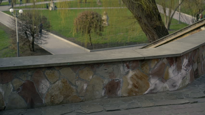 Young business woman coming out of an office building and sits on the stairs