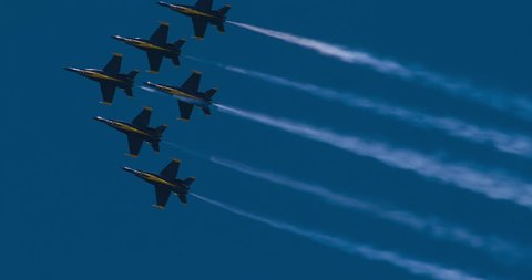 NORTH KINGSTOWN, RHODE ISLAND - CIRCA JUNE 2014:  Navy Blue Angels demonstration team in F18 Hornet fighter jets performing during air show. Jets flying togetherthen going in different directions. 4K.