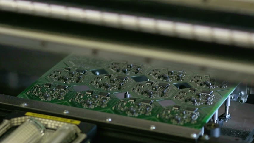 Machine collects electronic Board. Robot installer electronic components and chips for Assembly. Preparation of printed circuit boards on the machine. Modern  technology for integrated circuits. Royalty-Free Stock Footage #15702589