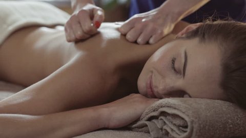 Massage concept. Beautiful young woman reciving relxing massage-