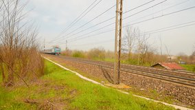 Train movement. Passenger trains in Italy. The camera follows the movement of the train. Passenger train fast passes by. European train and railway track infrastructure, rail, electric line trains. 