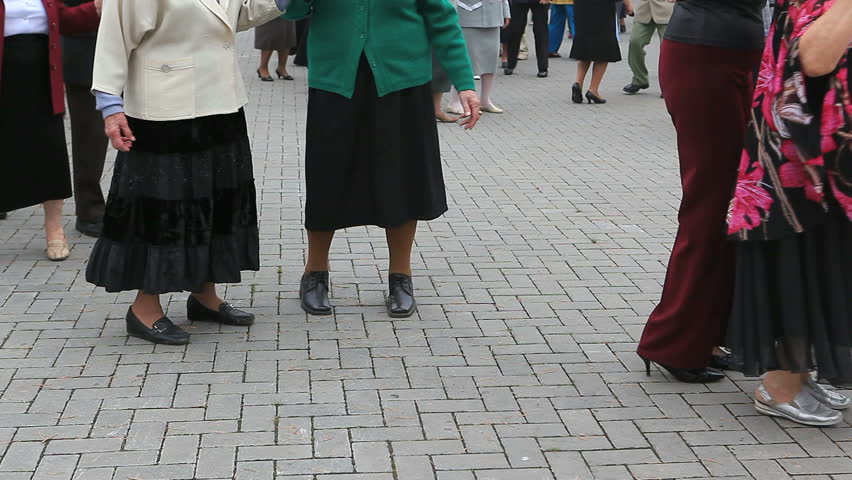 Active seniors dancing in the open air in the house of retired
