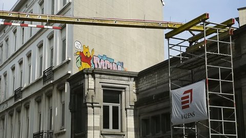 BRUSSELS, BELGIUM - CIRCa 2016: Winnie-the-Pooh graffiti showing fuck you off middle finger gesture on modern graffiti wall in the center of Bruxelles, Belgium