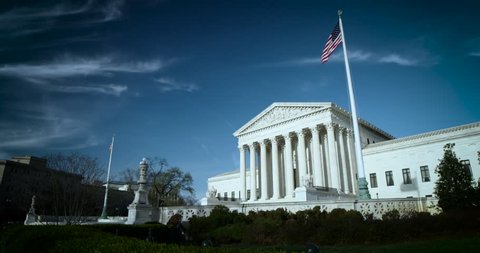 The US Supreme Court wide 4K blue sky high clouds nice flags. Available in 4K and HDR.