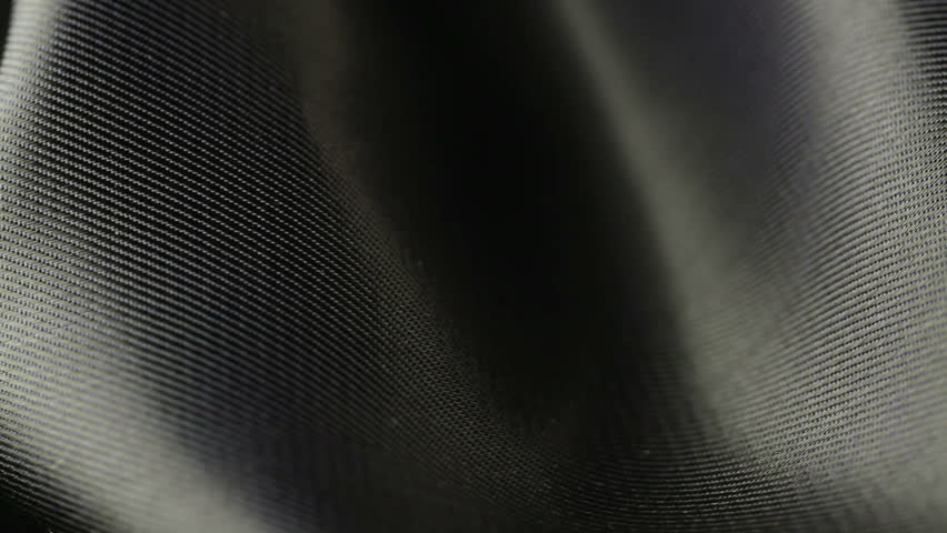background of black satin fabric closeup
