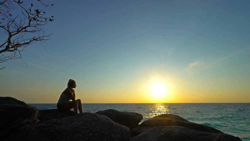 Girl is enjoying a Beautiful sunrise over the tropical sea. | Shutterstock HD Video #15726931