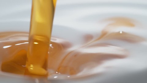 Pouing oil into milk and making splash. Shot with high speed camera, phantom flex 4K. Slow Motion.