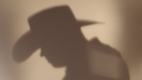 hat cowboy shadow playing guitar