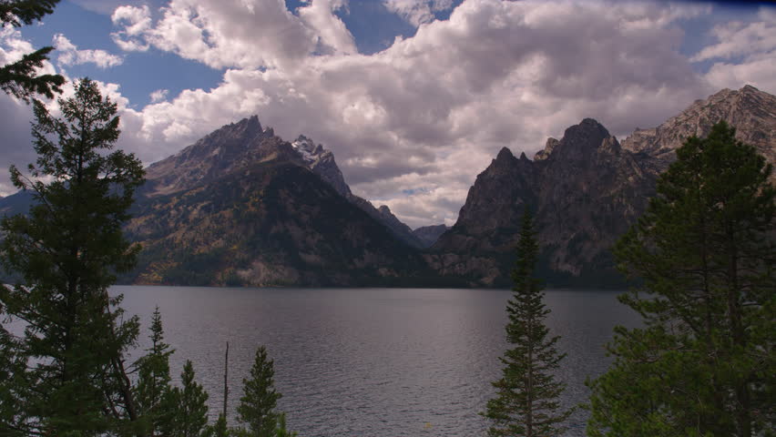 Scenic mountain view with reflections on lake in Grand Teton National Park, Wyoming. 4K.