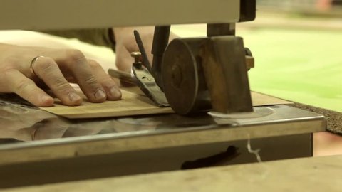 man stitching veneer