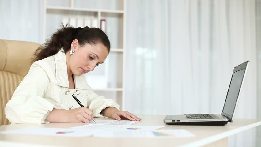 Business woman working with documents near laptop-1. DOLLY HD