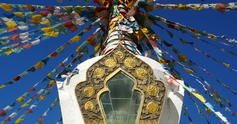 4k buddhist white stupa & flying prayer flags with blue sky background,shangrila yunnan,china. gh2_10499_4k