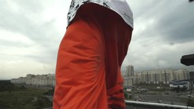 Slow motion shot of a young male roofrunner jumping from the roof over city landscape - Powered by Shutterstock - Get 15% off with code: PIKWIZARD15