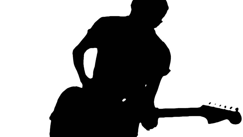 Silhouette of a young guitarist playing guitar energically