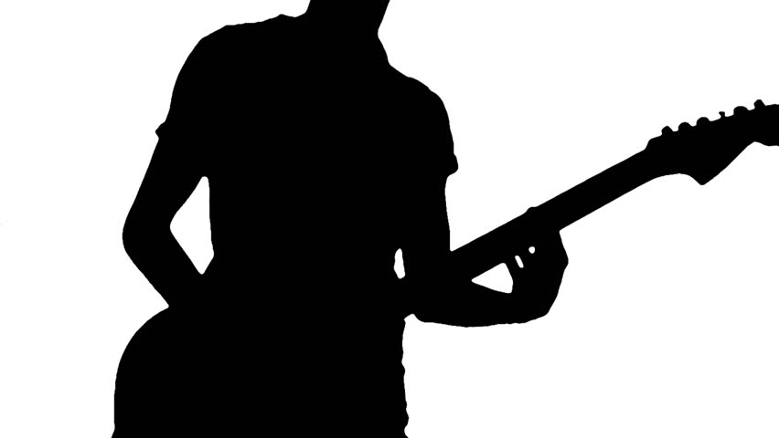 Silhouette of a young guitarist playing guitar energically