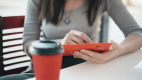 woman using tablet, drinking coffee in cafe
