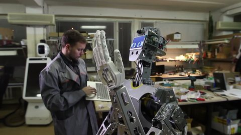 Engineer adjusts the robot