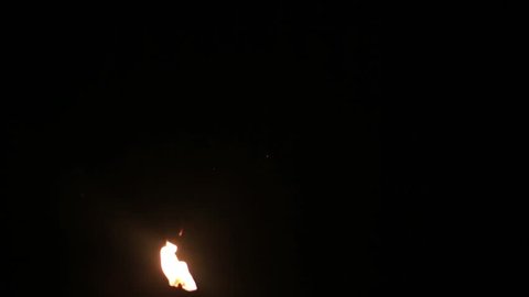 slowly burning paper in a black room