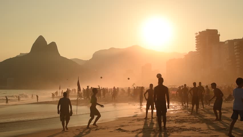 Silhouettes of Brazilians Playing Beach Football in Ipanema by Sunset. Royalty-Free Stock Footage #15799192
