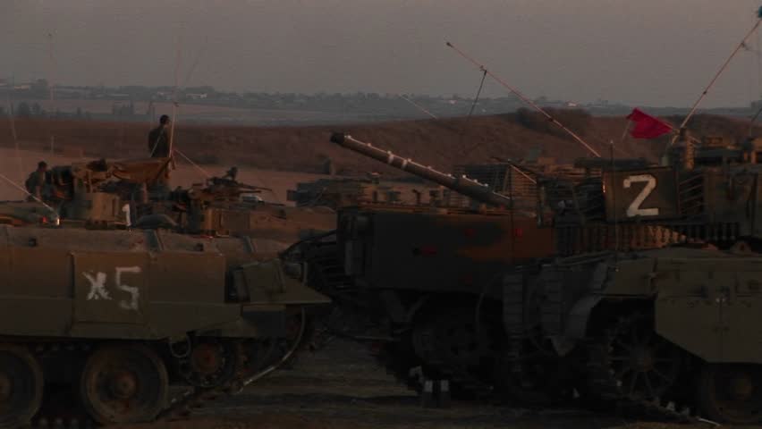 Israeli armored vehicles wait at an army staging post on the Gaza Strip border.