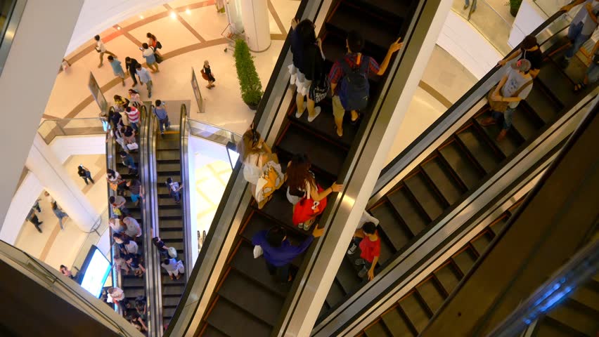Escalator 4k shopping mall crowd of people buy shop center centre last minute sale sales purchases rush hour very busy full of clients big shopping mall complex time lapse timelapse fast video 