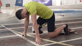Slow motion shot of determined athlete with prosthetic leg starting from blocks on track - Powered by Shutterstock - Get 15% off with code: PIKWIZARD15