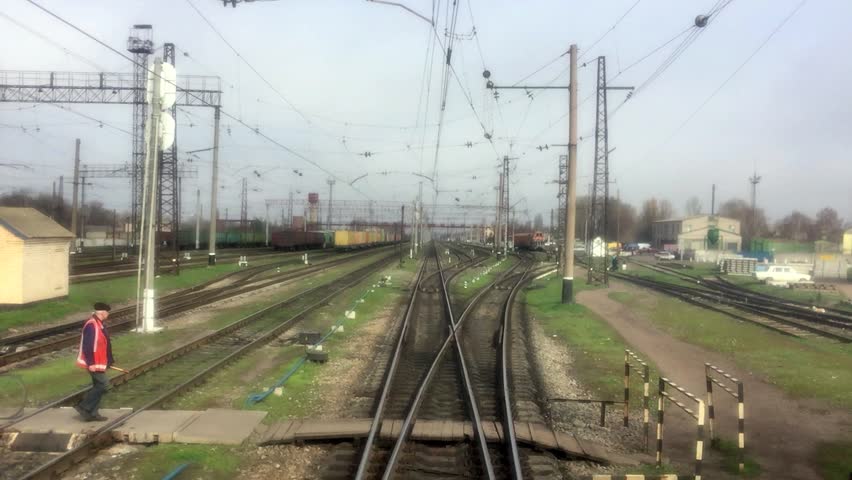Train departs from small railway station, the type of the last car of the train