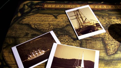 Golden compass, old maps and sailing ships photos, pan right 