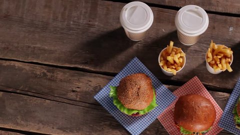 Hamburgers with fries on table. Top view of fast food. New dishes from the menu. Buy more and get discounts.