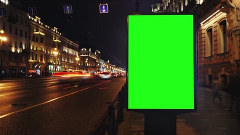  A Billboard with a Green Screen on a Busy Night Street.Time Lapse.