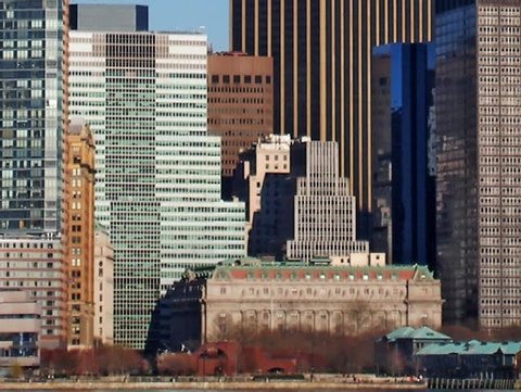 Detail of Buildings in lower Manhattan NY from the east river.  Panning left to right.