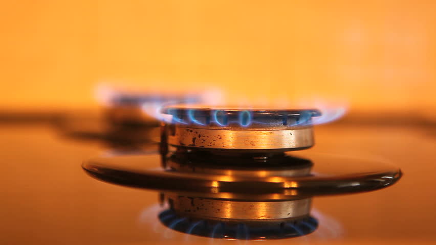 Two gas ring burners on a home cooker, shallow depth of field