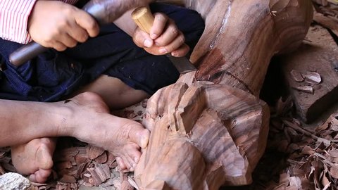 Burmese man are making wooden souvenirs for tourists in Bagan, Myanmar. Wood Carving is a traditional handicraft in Myanmar