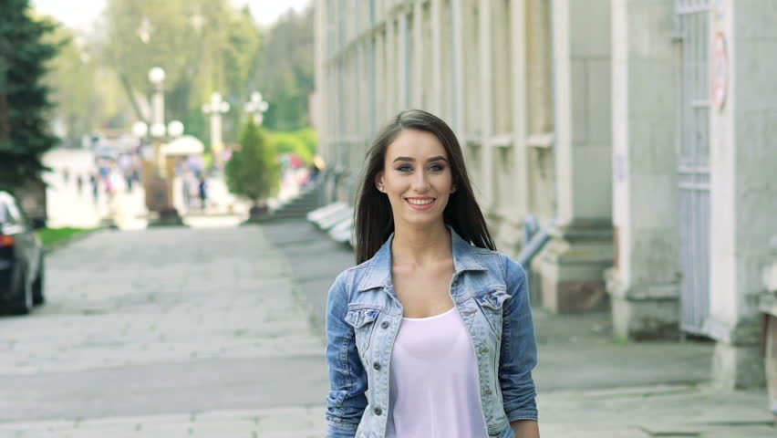 Fashion girl walking and posing on camera. Slowly