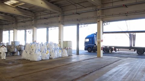 Milan, Italy - March 2016: Time lapse of warehouse workers loading a truck for deliveries.