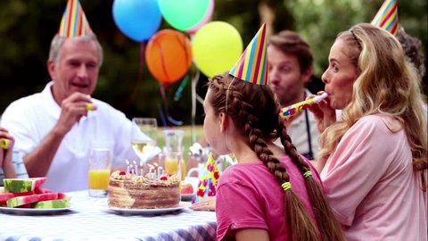 Girl blowing birthday candle in cinemagraph style Video stock