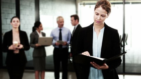Businesswomen looking at documents standing in the office - cinemagraph Adlı Stok Video