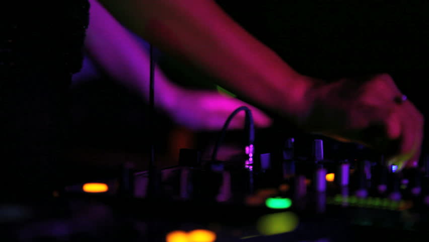 DJ playing music at the nightclub. hands close up