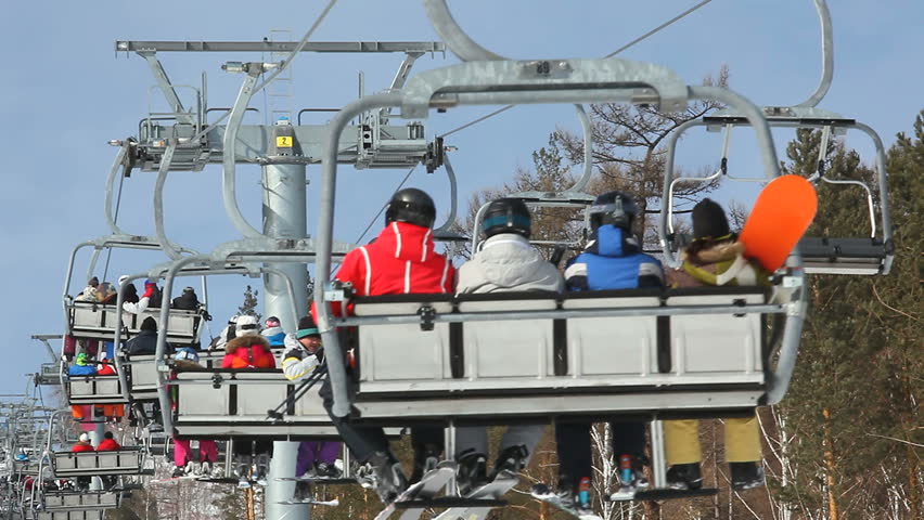 Ski lift at the ski resort lifts people on the mountain