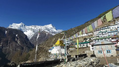  A POV video of a tourist who walks toward the Tibetan Buddhism stupa in Namche Bazaar, the main town along the Everest base camp hiking trail in Nepal. Kongde Ri is the mountain in the background.
