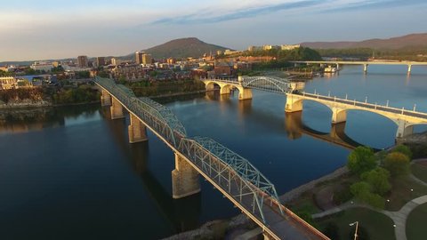 Aerial of the city of Chattanooga at sunrise along the river front. Flying above Chattanooga Tennessee in the pre dawn light. Urban American town in the southeast United States. 